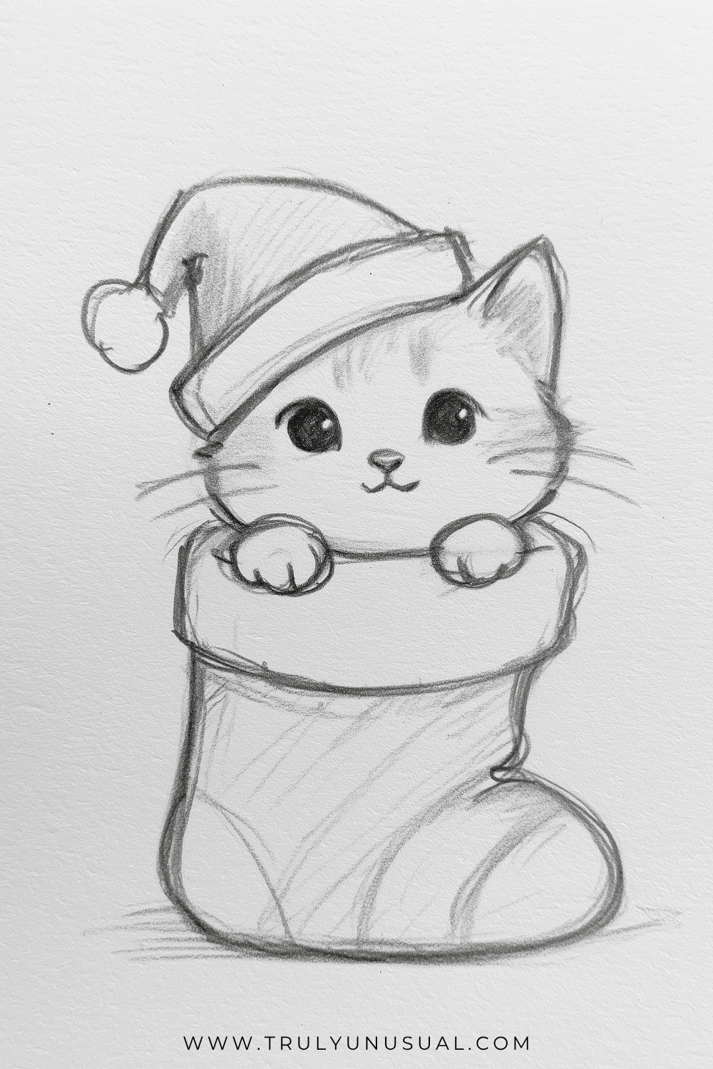 Cute Christmas kitten pencil drawing featuring an adorable little cat peeking out of a large Christmas stocking. The kitten has a round face, big sparkling black eyes, a tiny triangular nose, a smiling mouth, delicate whiskers, and one pointed ear visible beneath an oversized Santa hat with a fluffy brim and round pom-pom. Its two small front paws rest on the thick, folded cuff of the stocking, which has a rounded toe and subtle diagonal stripe patterns. Hand-drawn graphite pencil illustration with soft shading and sketch-style outlines on textured white paper.