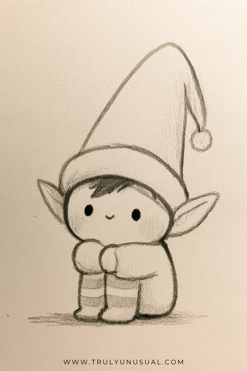 Cute and easy Christmas elf pencil drawing featuring a small, adorable elf with large pointed ears, a sweet smiling face, round black eyes, and softly shaded cheeks. The elf wears an oversized floppy Christmas hat with a fluffy pom-pom, a cozy scarf, and striped leggings. Delicate graphite pencil outlines and gentle shading create a charming, hand-drawn Christmas character on textured paper, perfect for kids and beginners looking for cute Christmas drawing ideas.