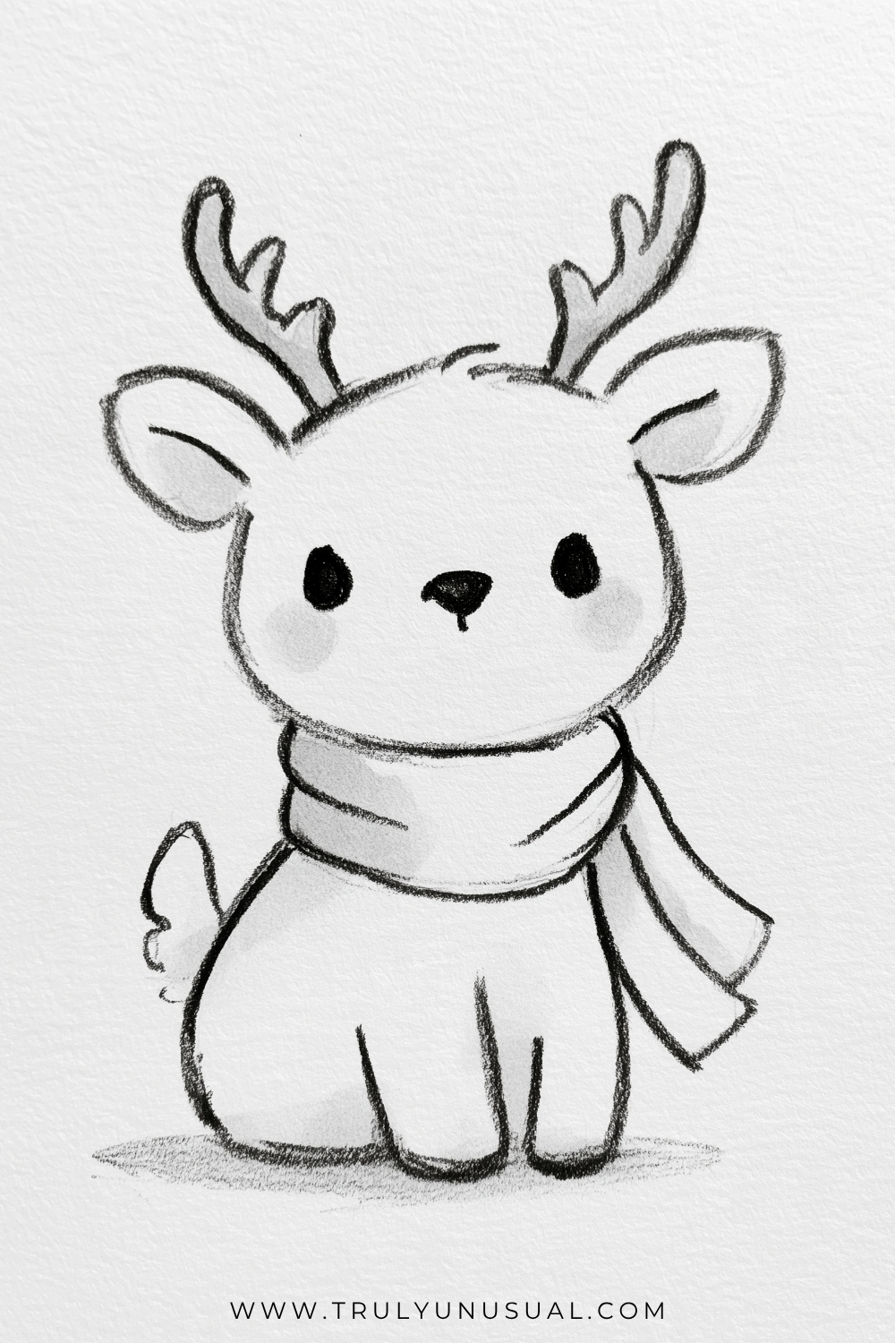 Cute Christmas reindeer pencil drawing featuring a small, chubby reindeer sitting upright with a large rounded head, two branching antlers, oversized ears, and short legs. The reindeer has black oval eyes, a tiny dark nose, softly shaded cheeks, and a little fluffy tail. A cosy winter scarf is wrapped around its neck, with two loose ends hanging down on one side. Simple black-and-white hand-drawn pencil illustration with soft shading on textured white paper.