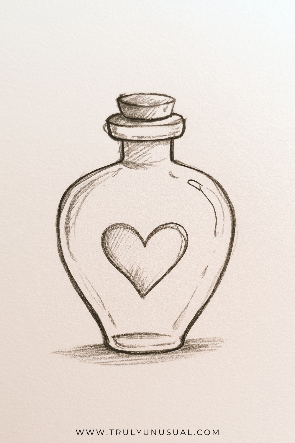 Pencil drawing of a round glass bottle with sloping shoulders, a short neck, a thick rim and a small stopper. A large outlined heart with light diagonal shading decorates the centre, while curved reflection marks and a horizontal ground shadow suggest glass and depth.
